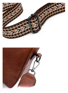 Detail of brown lychee leather bag with woven strap and gunmetal adjustable hardware