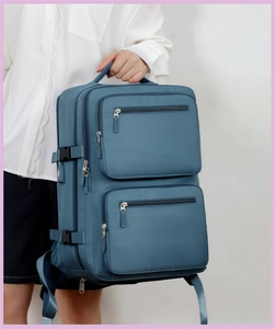 Blue business laptop backpack detail with USB port and multi-layer zipper pockets
