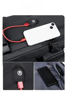 Detail of laptop backpack showing external USB charging port and red cable connection