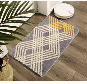 Detail view of plush geometric stripe rug on wooden floor with home decor elements