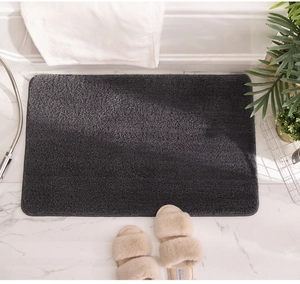 Detail of soft dark grey plush bathroom rug on marble floor with home decor