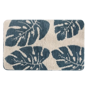 Absorbent monstera leaf doormat in navy blue and cream white with non-slip backing