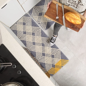 Absorbent non-slip kitchen mat set with dark grey base and yellow geometric patterns