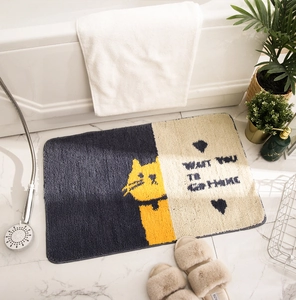 Detail of cartoon cat bath mat with plush fibers and Want You To Go Home text