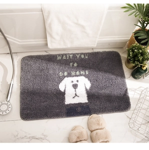 Detail of gray soft plush bath mat with cartoon dog and Wait You To Go Home slogan