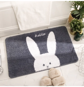 Close-up of thick grey bathroom mat featuring a cute white rabbit and hello text