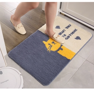 Absorbent cartoon cat bath mat with thick plush texture shown in a cozy home setting