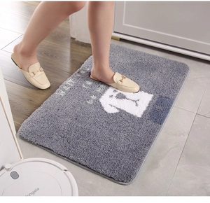 Detailed view of dark grey plush bath mat with cute white dog and soft fiber texture