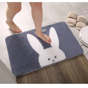 Close-up of thick grey bathroom mat with white rabbit design showing soft plush texture