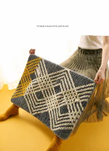 Close-up of tufted geometric bath mat showing thick texture and soft yellow pattern