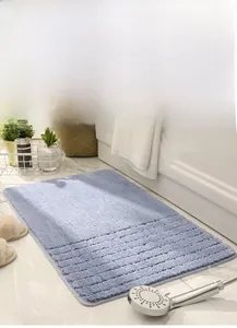 Detailed view of light blue rectangular anti-slip bath mat with soft striped texture
