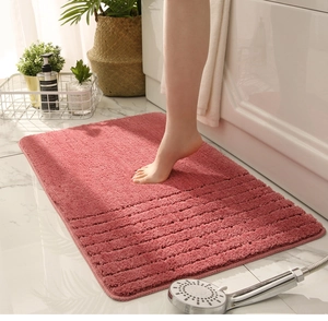 Detailed texture of a pink absorbent microfiber bath mat with stripe design