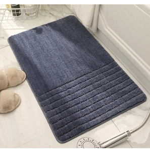 Detail showing the thick plush texture and striped design of the navy blue bath mat