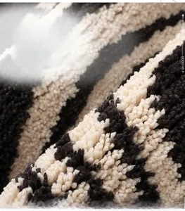 Macro view of high-density soft fiber texture on black and white striped floor mat