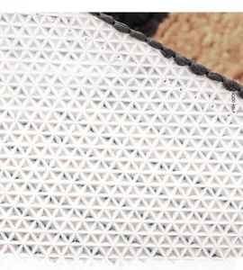 Detail of TPR non-slip backing on minimalist floor mat showing geometric patterns