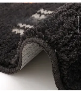 Detailed macro view of thickened plush fibers and anti-slip backing on the gray bath mat