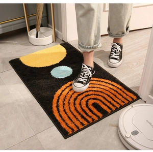 Detail of a thick plush rug featuring modern geometric patterns and a robotic vacuum