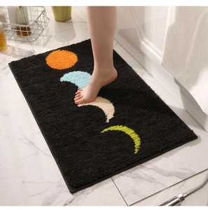 Détail du tapis de bain épais avec phases de lune colorées sur tissu noir doux