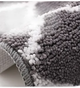 Macro shot of thick fiber bathroom mat showing soft texture and high-density grey-white pile