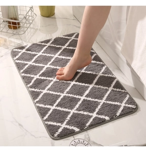 Detail of gray and white diamond pattern bath mat with soft fiber texture and overlock edge