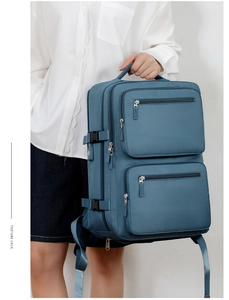 Detail view of large business backpack side with buckle and reinforced handle in misty blue