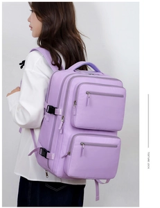 Detail view of purple water-resistant nylon business backpack with multiple zip pockets