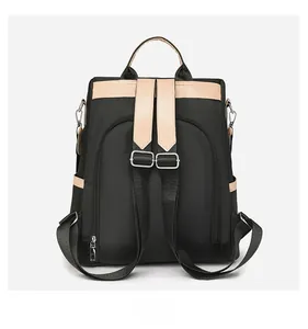 Rear view of black nylon backpack with beige leather trim and anti-theft zipper back