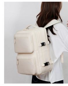 Side view of beige business backpack with two front pockets and side compression buckles