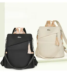 Detail view of stylish nylon backpacks with contrast colors and tassel charms