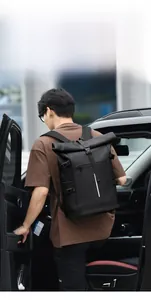 Close-up of waterproof roll-top backpack with reflective stripe on urban street scene