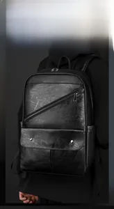 Detail view of the black pebbled PU leather backpack with magnetic buckle pockets