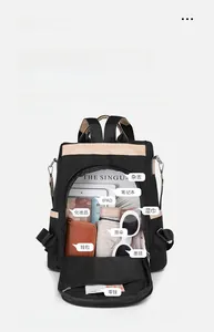 Top view showing large capacity interior of a nylon backpack with iPad and travel items