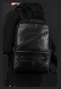 Detail of black PU leather backpack showing premium litchi texture and stylish rivets