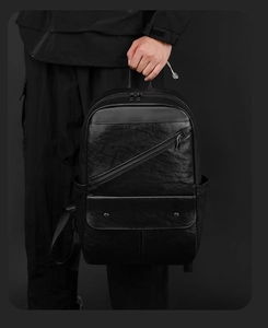 Close-up of black PU leather texture with diagonal zipper and flap pocket details