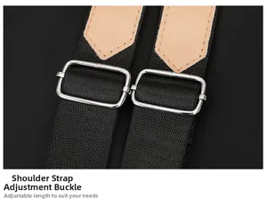 Detail of adjustable silver metal buckles on black shoulder straps with brown leather finish