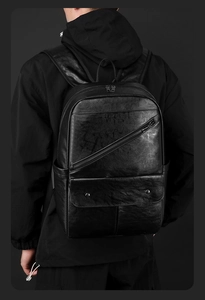 Close-up of black matte PU leather backpack featuring diagonal zipper and flap pocket
