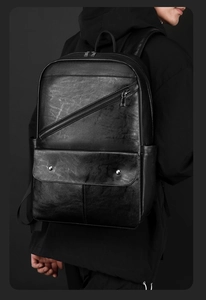 Detail of black PU leather business backpack with diagonal zipper and flap pocket