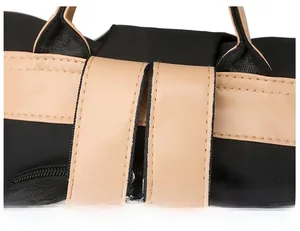 Close-up of contrast color strap junction and double stitching on the black PU backpack