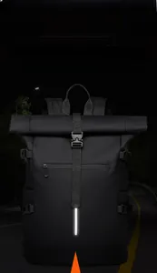 Detail view of the waterproof roll-top backpack featuring high-visibility reflective strip