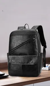 Close-up of black PU leather backpack with diagonal zipper pocket and metal buckle detail