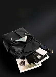 Detail of black PU leather backpack showing large capacity and multi-pocket interior storage
