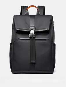 Front view of black functional backpack with waterproof nylon and orange handle detail