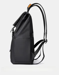Side view of black business backpack featuring breathable mesh straps and orange handle detail