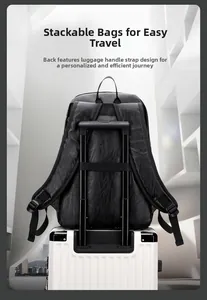 Detail of the luggage strap on a black PU leather backpack for easy travel attachment