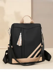 Detail view of contrast color PU leather backpack with white tassel and side pockets