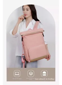 Detail view of pink backpack showing 15.6 inch laptop compartment and luggage strap