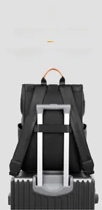 Detail of waterproof business backpack with luggage strap secured on a suitcase handle