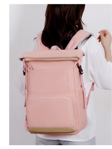 Detail of light pink waterproof insulated backpack showing side buckles and zippers