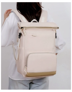 Detail of a large cream-colored insulated cooler backpack with waterproof fabric on a model