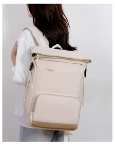 Detail view of the roll-top closure and reinforced straps on a minimalist insulated backpack